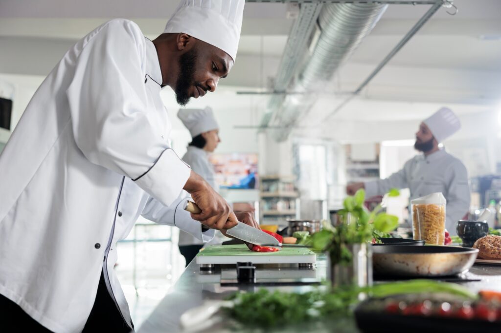 Head chef in restaurant professional kitchen preparing delicious meal