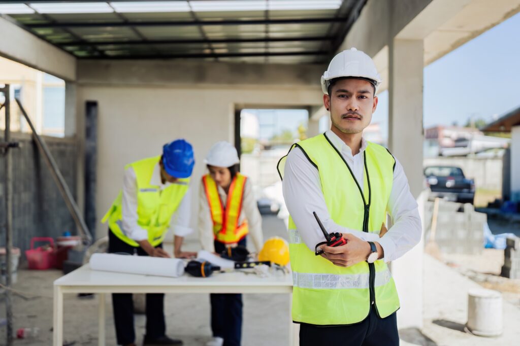 Portrait of Industry maintenance engineer man wearing uniform and safety hard hat on factory station