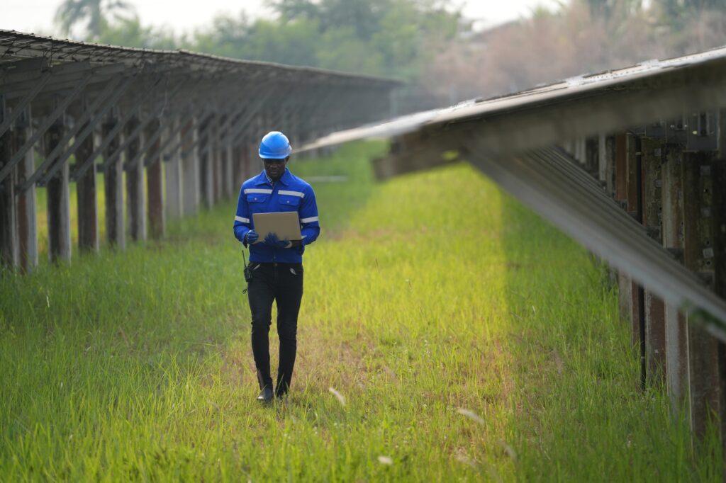Solar power plant engineer examining photovoltaic panels. technician maintenance electric solution.